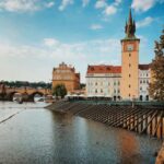 Beautiful view of historic buildings and Vltava River in Prague, showcasing the iconic architecture.