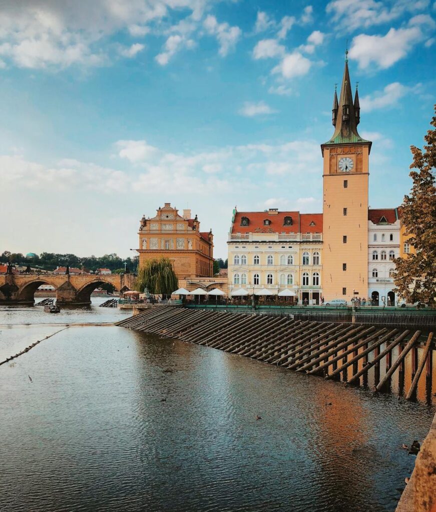 Beautiful view of historic buildings and Vltava River in Prague, showcasing the iconic architecture.