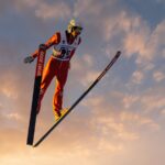 a man flying through the air while riding skis